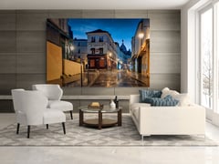 Off the Clock on a grey wood panel wall above white armchairs, a glass coffee table, and a cream sofa. (thumbnail 5)