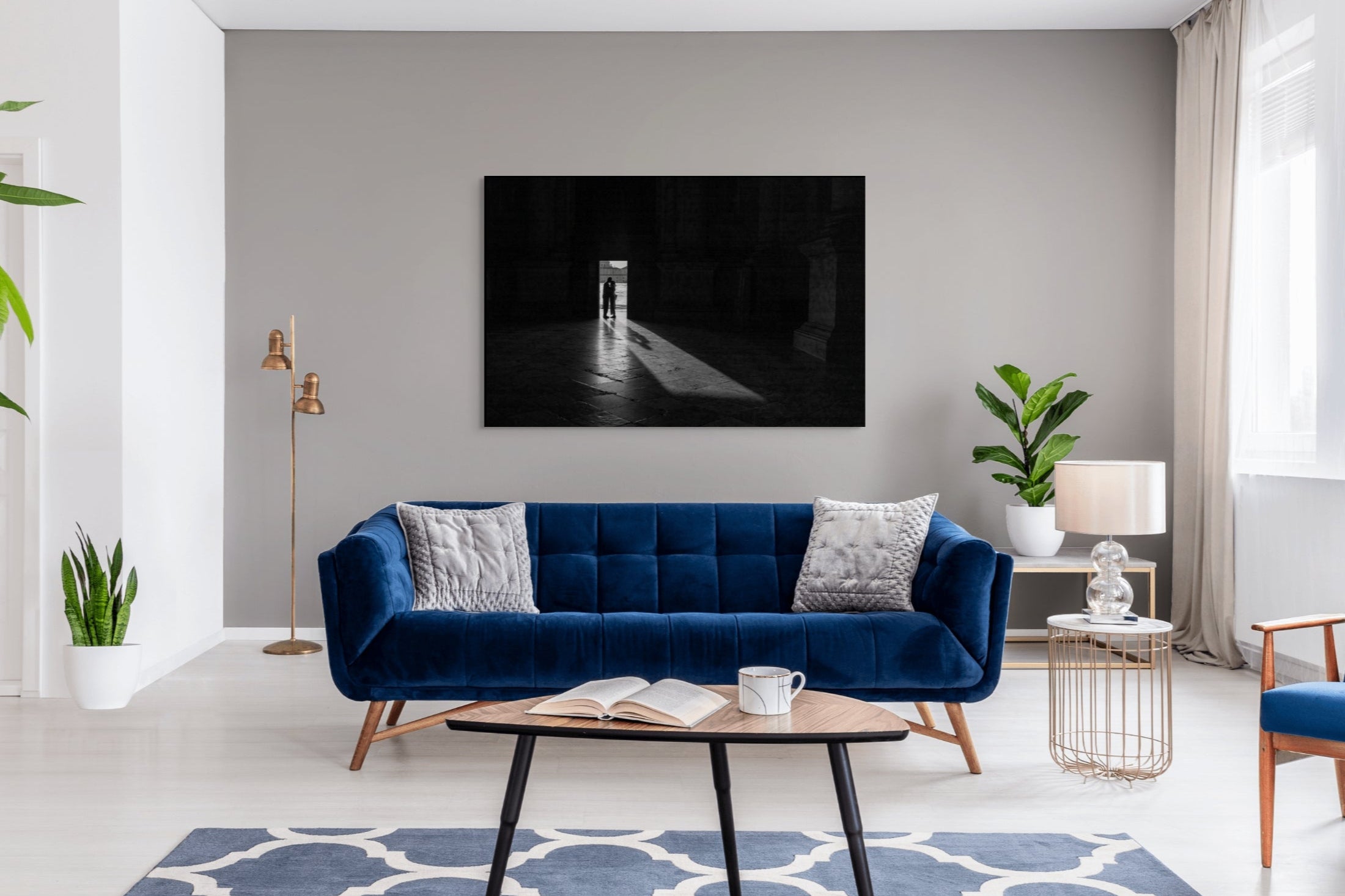 Luxury black and white fine art print titled Two Souls in Sacred Stillness by Sherry Keene, Refocus Award Honorable Mention, featuring a silhouetted embrace in the light-filled doorway of San Giorgio Maggiore, Venice – shown as a 72-inch gallery-mounted statement piece in an elegant designer living room