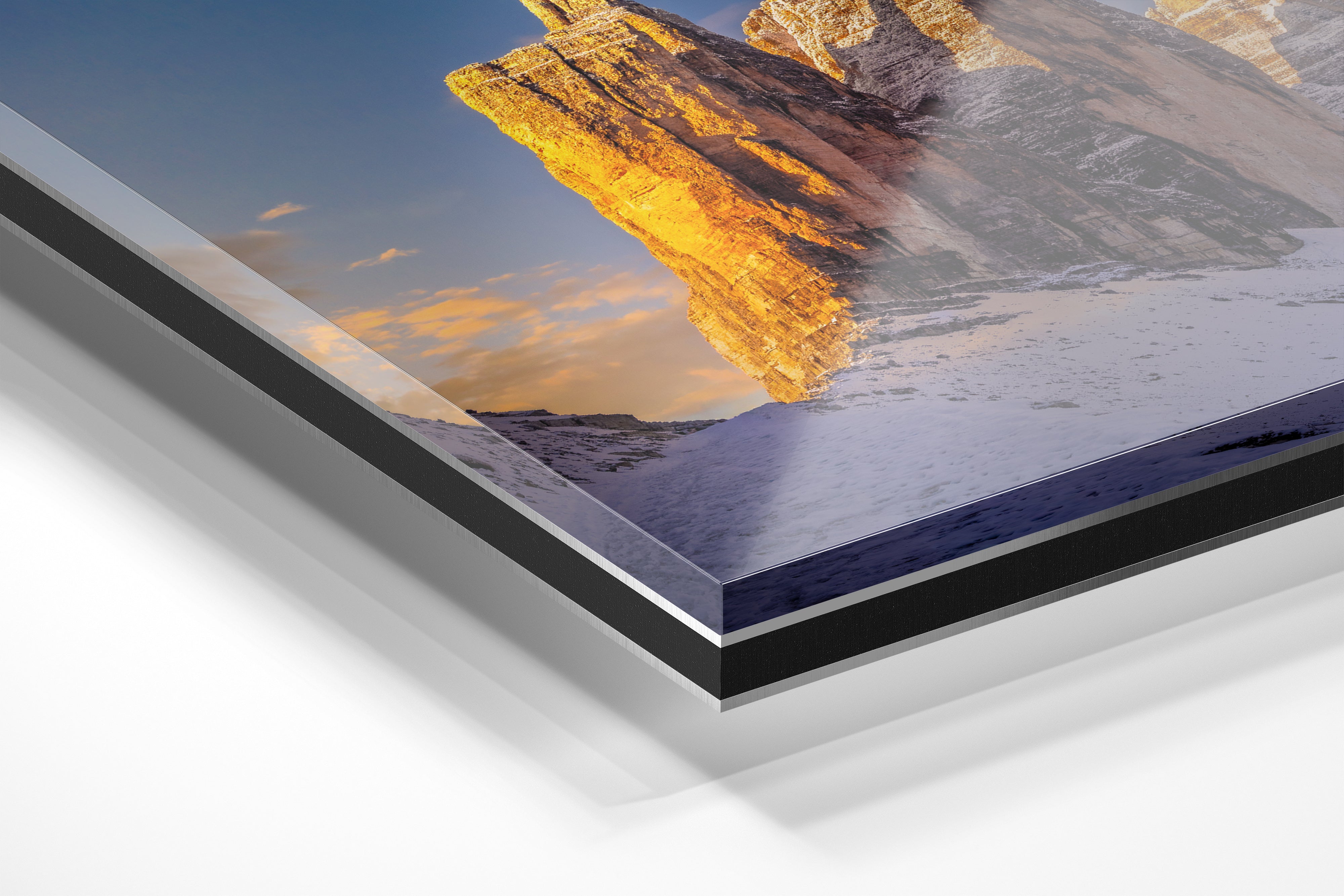 Close-up detail of the fine art print “Cold Fire on Tre Cime di Lavaredo (Drei Zinnen)” by Sherry Keene, mounted under acrylic glass on Alu-Dibond. The Dolomites glow in golden morning light after a snowstorm, printed with museum-quality precision and luminous depth — luxury mountain wall art for collectors, modern interiors, ski chalets, or alpine vacation homes.