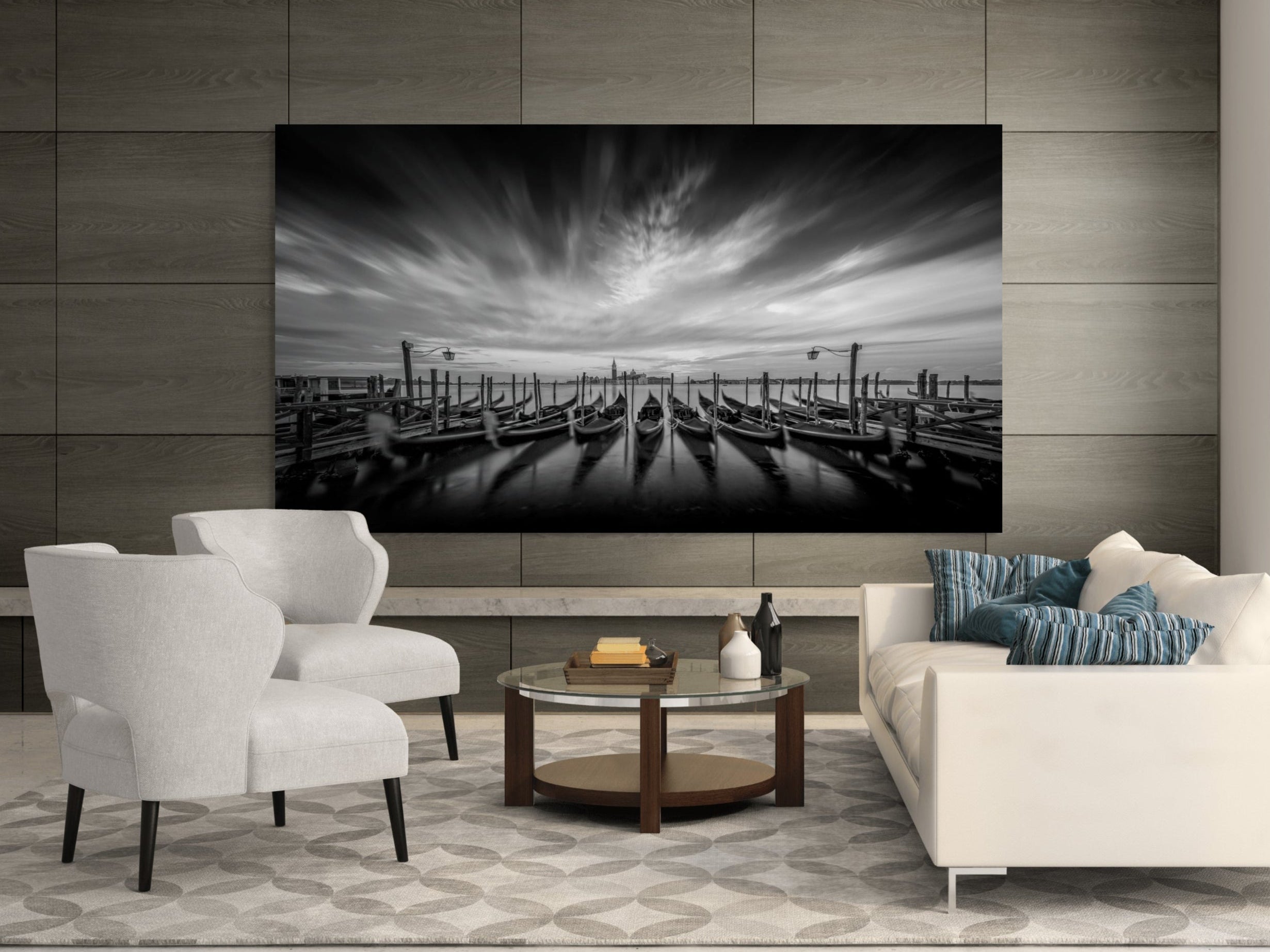 Large-format 90-inch black and white fine art photograph Eternal Stillness (Gondolas Across the Lagoon) by Sherry Keene, displayed in a contemporary European living space with minimalist textures, soft neutrals, and architectural light — a collector-grade statement piece printed on museum-quality substrate